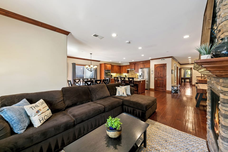 Sink into the plush sectional and savor the warmth of rich wood tones flowing seamlessly from your living space into the gourmet kitchen.