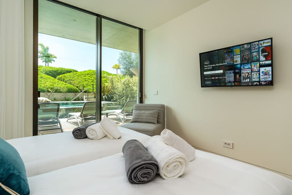Private suite with smart TV and direct access to the pool terrace.