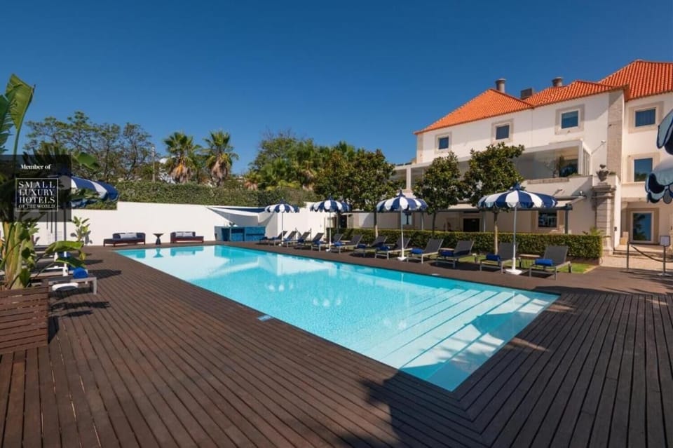 Savor sunny resort vibes with loungers beside the shimmering pool.