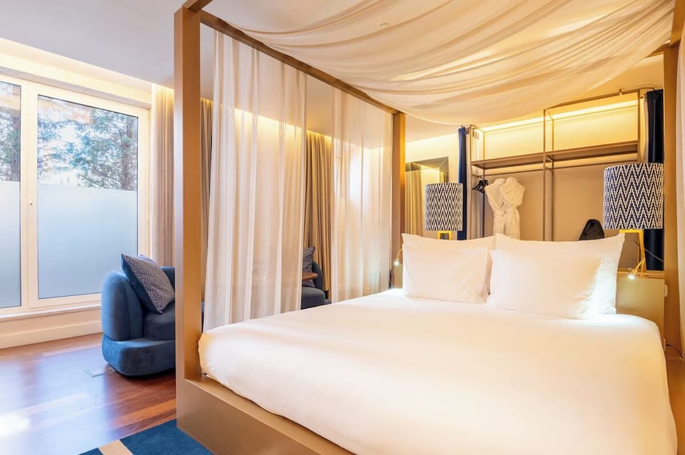 Wake slowly in a dreamy canopy bed beside sunlit windows.