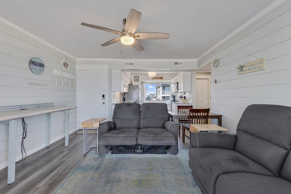 Relax in your bright, airy living space with comfortable recliners and an open layout perfect for unwinding after beach adventures.