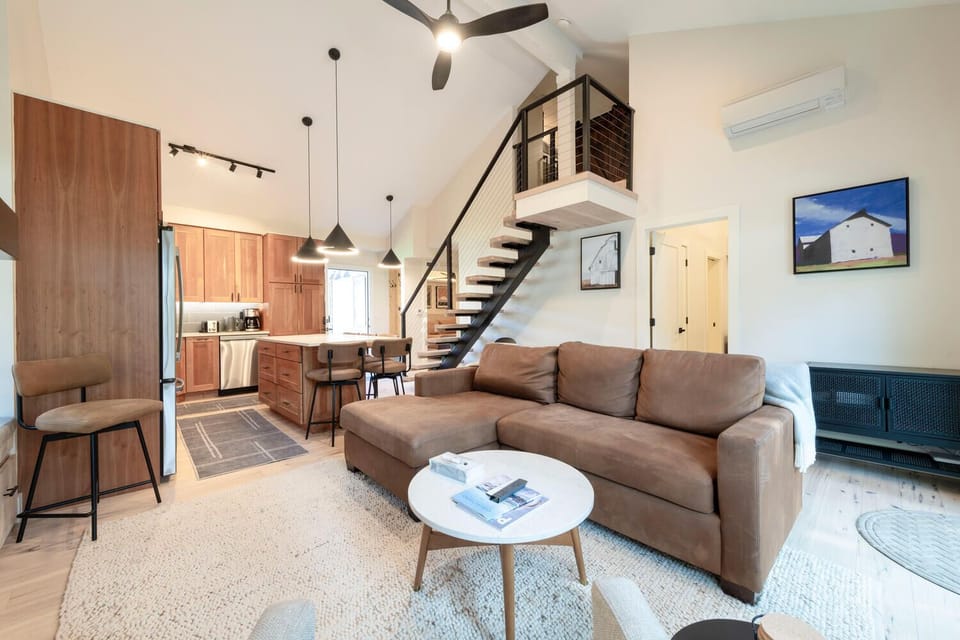 Open kitchen with new appliances & island seating.