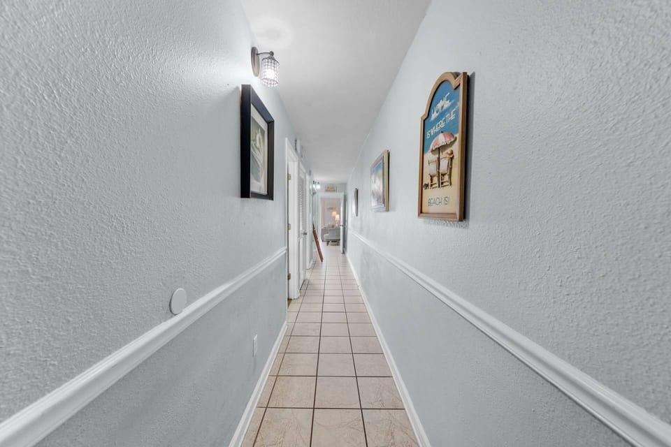 "Home is where the beach is" — and this hallway says it all! Step inside and let the vacation begin.