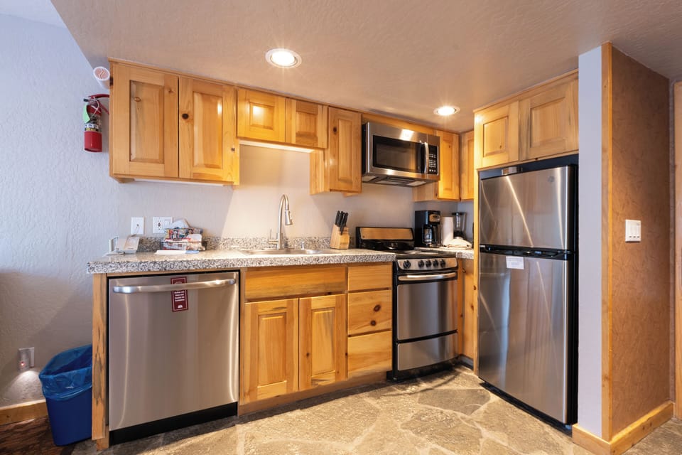 Cook with ease in a warm kitchen with stainless appliances.