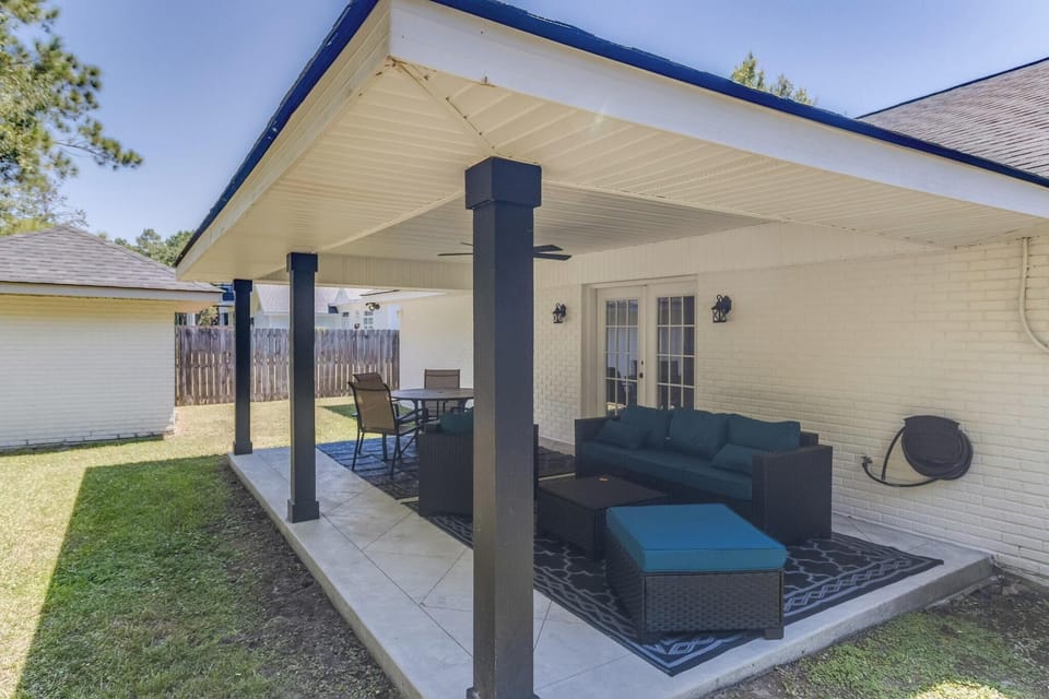 Covered back porch with outdoor seating—ideal for morning coffee or relaxing in the shade.