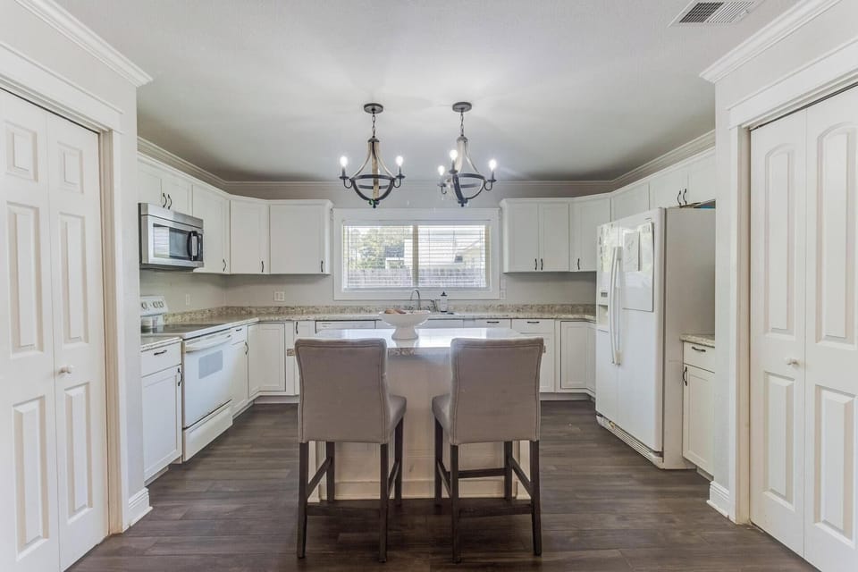 Fully equipped kitchen with modern appliances and adjacent dining space for easy group meals.