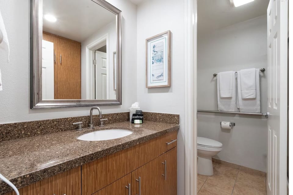 Refresh comfortably at the spacious vanity with bright mirror lighting.