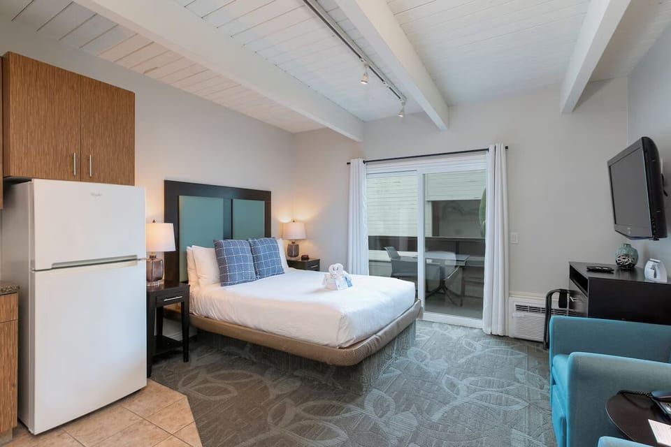 Unwind in a bright king bed retreat with balcony doors.