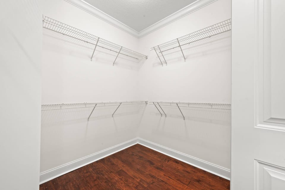There is plenty of room to store all of your hanging clothes and luggage in this spacious walk-in closet (primary bedroom).
