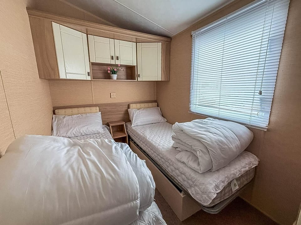 Cozy twin bedroom with natural light and ample storage
