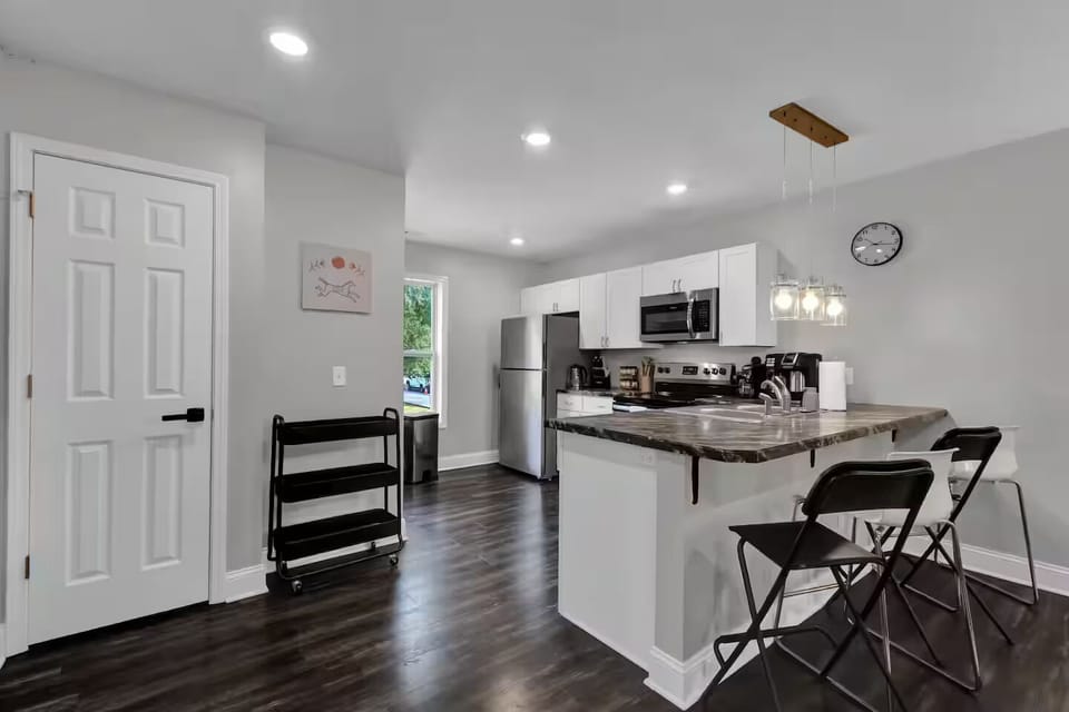 Open kitchen with island seating and modern appliances