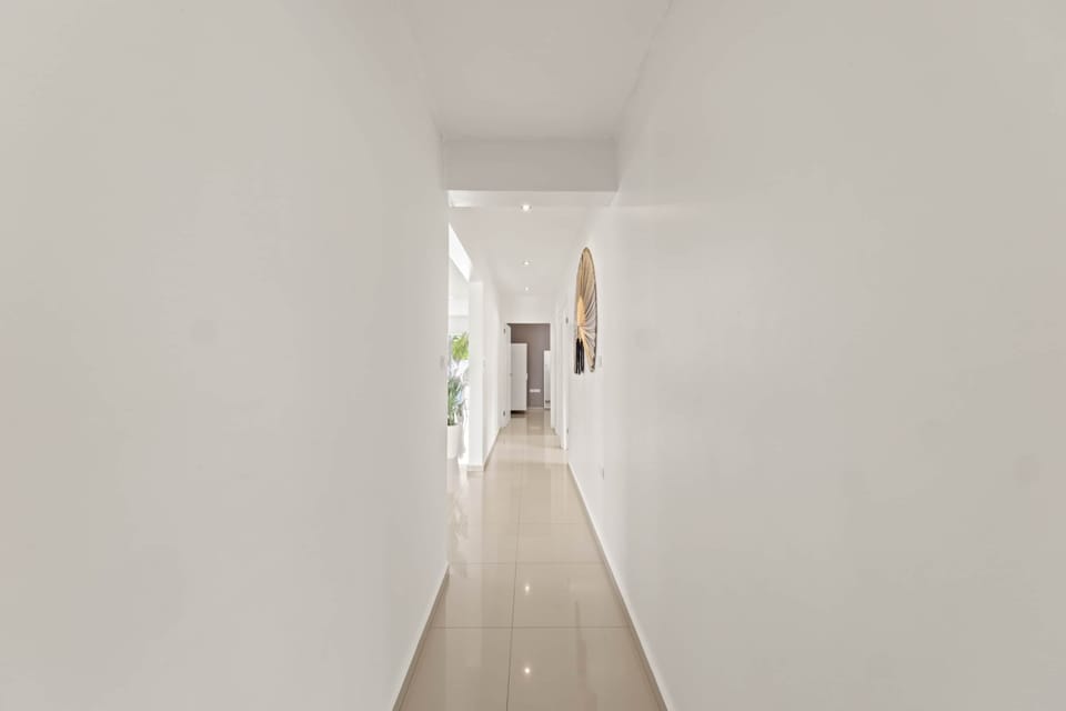 Hallway leading to the 3 bedrooms separated from the living room