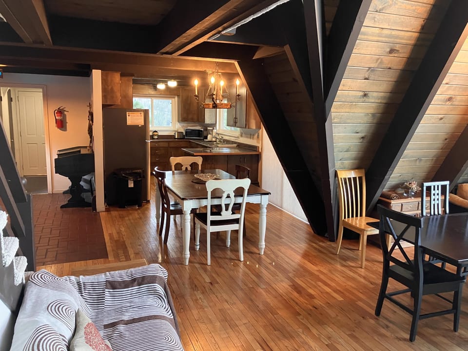 Cozy attic loft with dining space and fully equipped kitchenette.