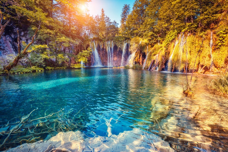 Majestic view on turquoise water and sunny beams in the Plitvice Lakes National Park