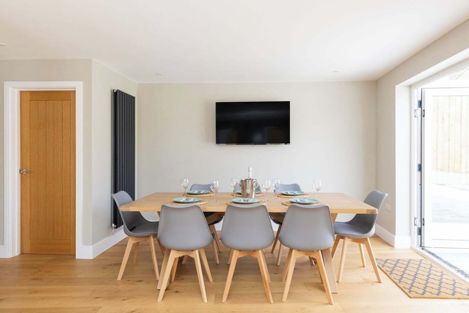 A modern dining space with a TV for casual, relaxed meals.