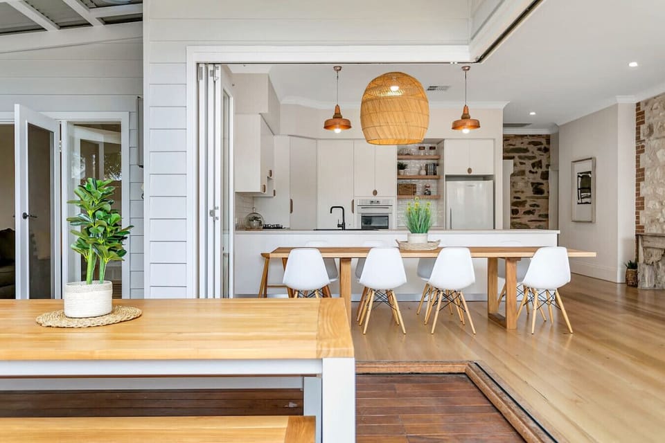Gather for meals around the spacious dining table, with plenty of room for everyone to dine together inside and out.