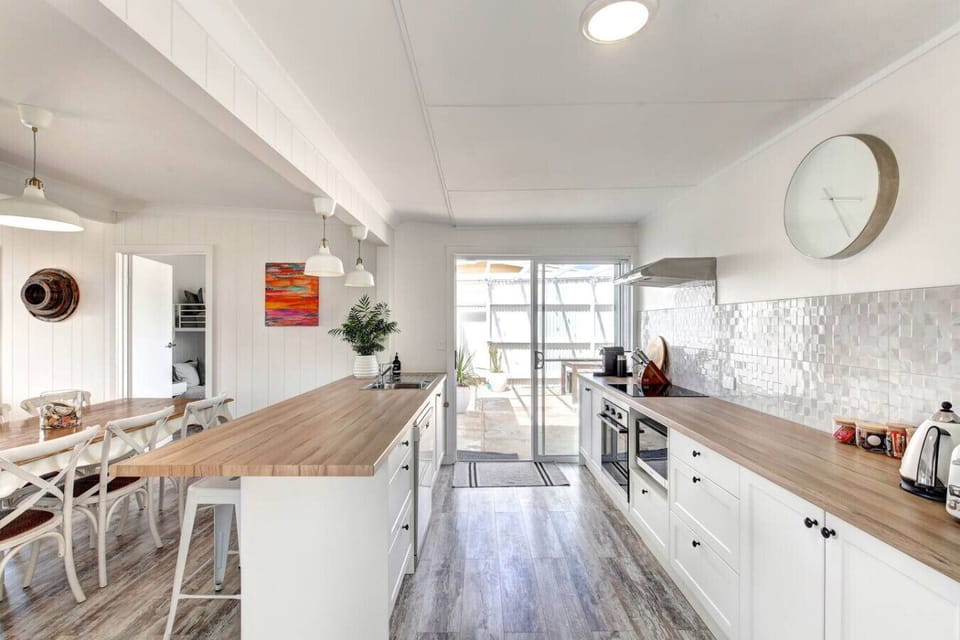 Cook with ease in the bright, fully equipped kitchen, where open space and coastal styling make every meal feel effortless.