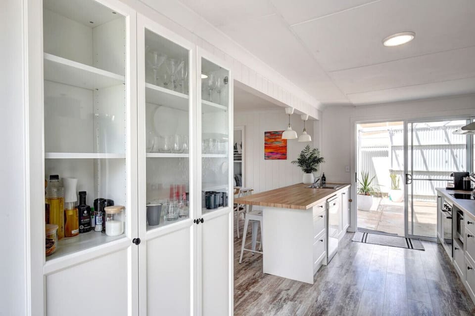A clever pantry stores cooking essentials and glassware.