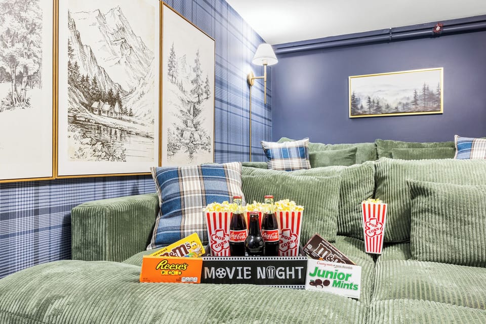 Cozy theater room with plush seating, oversized screen, and warm cabin-style accents—perfect for movie nights in the mountains.