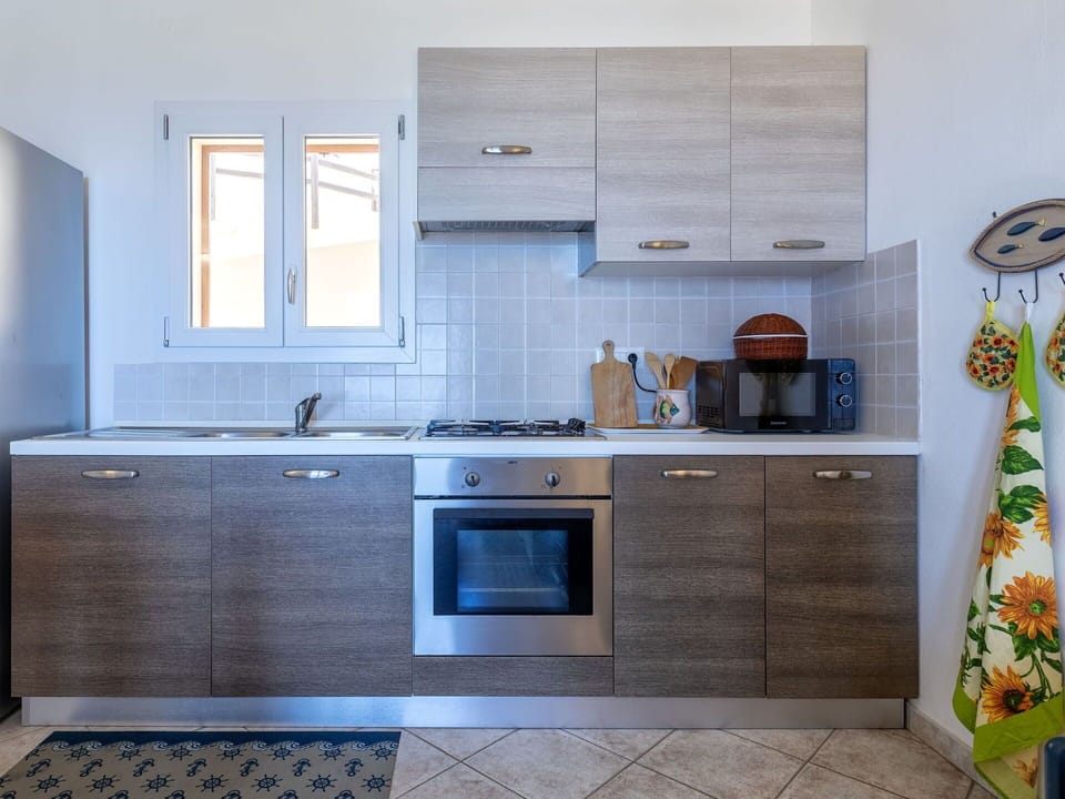 Kitchen, Kitchen Appliance, Countertop, Major Appliance, Cabinetry, Flooring, Kitchen Sink, Wood, Home Appliance, Kitchen Stove