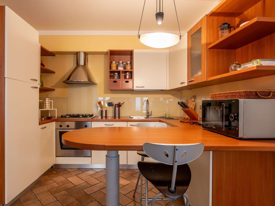 Furniture, Kitchen, Countertop, Kitchen Appliance, Interior Design, Cabinetry, Major Appliance, Wood, Flooring, Light Fixture
