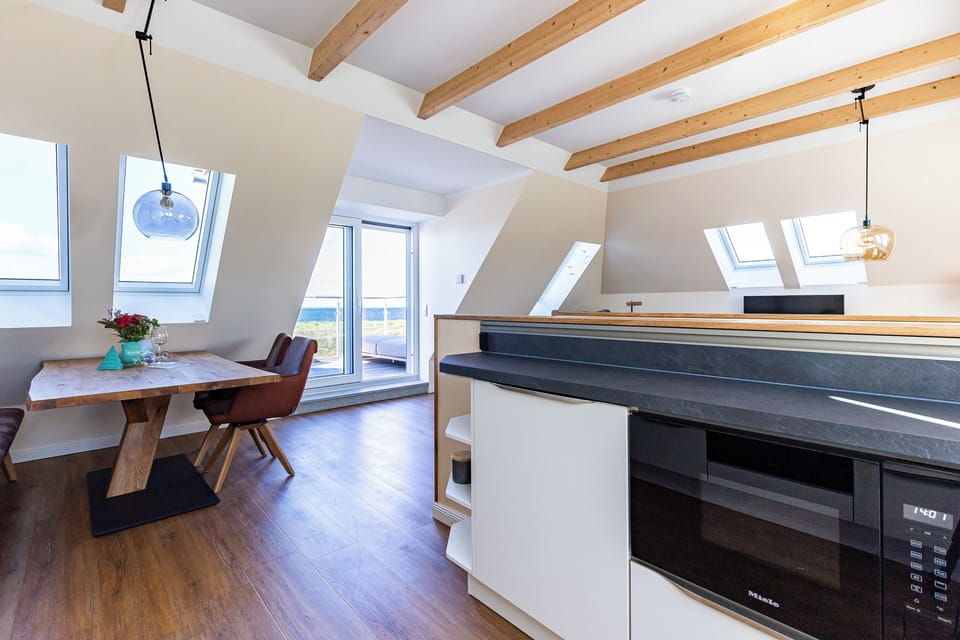 Modern Kitchen with Dining Table and Balcony Access