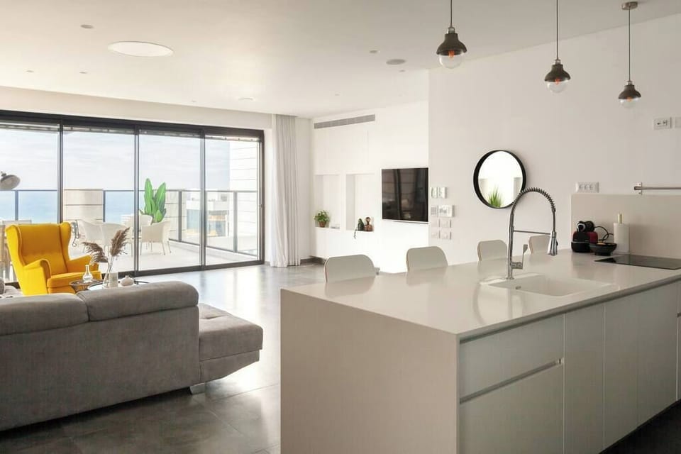 Central island invites casual gatherings, reflecting spacious design and proximity to transit and local hotspots.