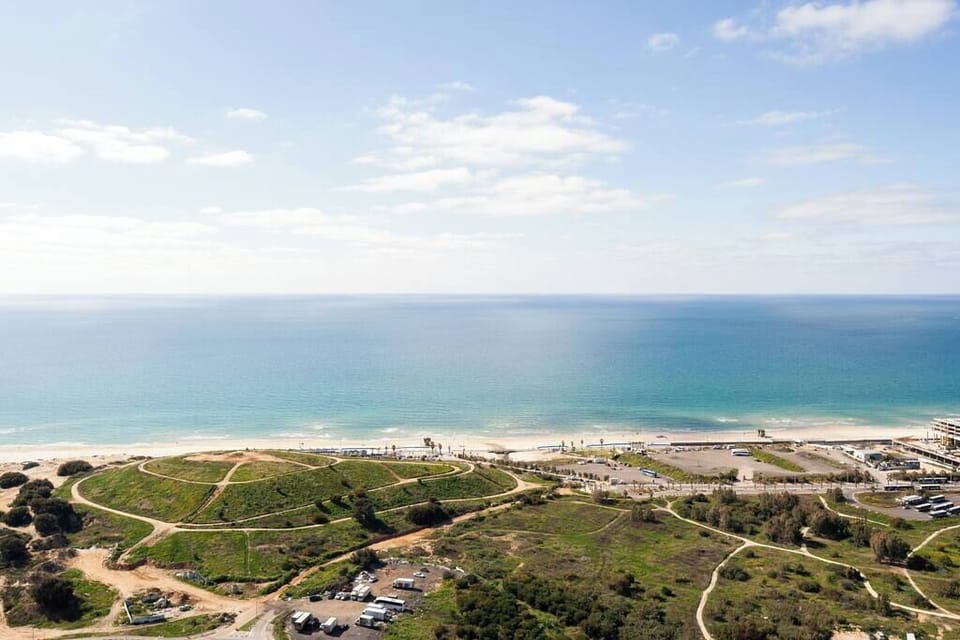 Panoramic coastline view delivers breathtaking scenery, placing you near beaches and vibrant city experiences below.