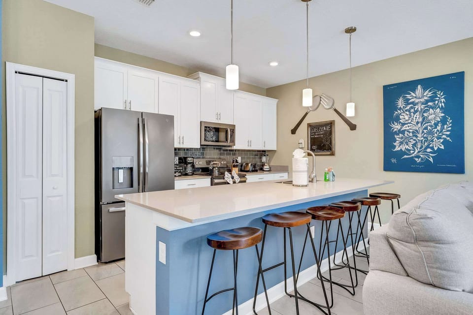 Prepare and share meals together in a modern kitchen with generous space and beautiful lighting.