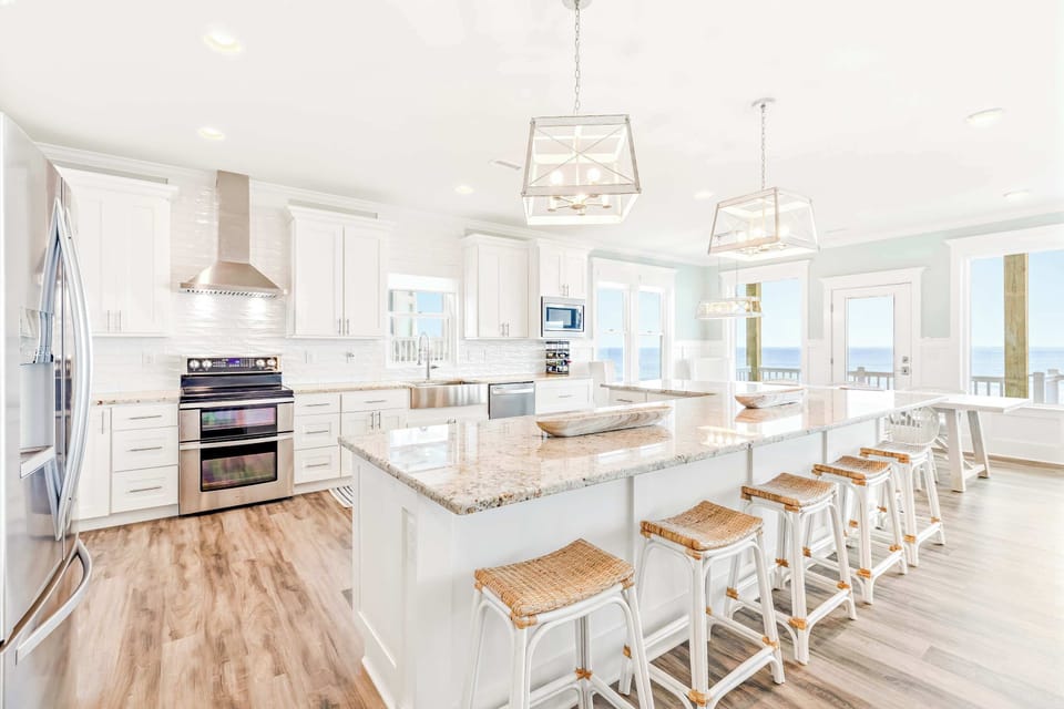 Bright Gourmet Kitchen w/ Large Island Seating, Stainless Steel Appliances, and Coastal Views