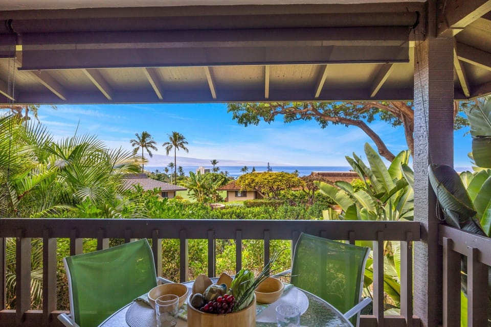 Relax on your private balcony overlooking lush greenery and the sparkling ocean beyond