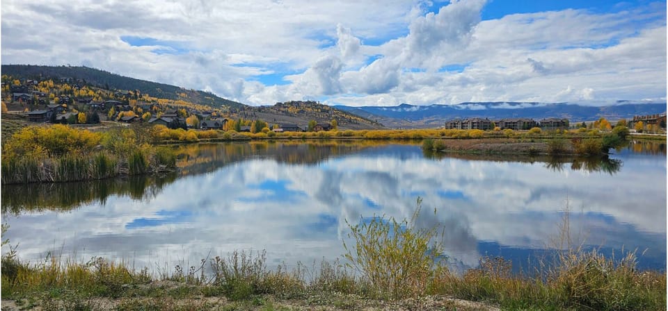 Golden aspens, mountain reflections, and peaceful trails—just steps from your front door. Fall in Granby is pure magic, and this is the view that greets you on your morning walk. Come stay where the colors shine brightest.