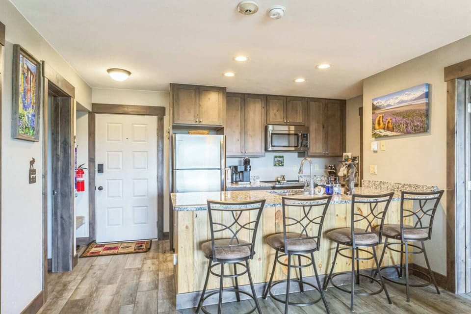 Fuel your mountain adventures from this fully stocked kitchen—complete with coffee station, granite counters, and plenty of space to prep, plate, or pour a glass of wine while chatting at the bar.