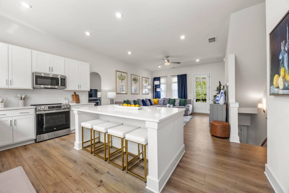 Contemporary Kitchen & Living | Modern Atlanta Townhome Rental Enjoy a seamless layout w/ stylish finishes & cozy group-friendly seating.