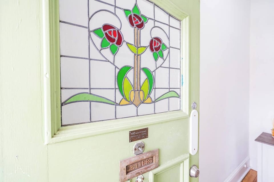 A delicate stained-glass detail welcomes you with heritage charm from the very first step inside.