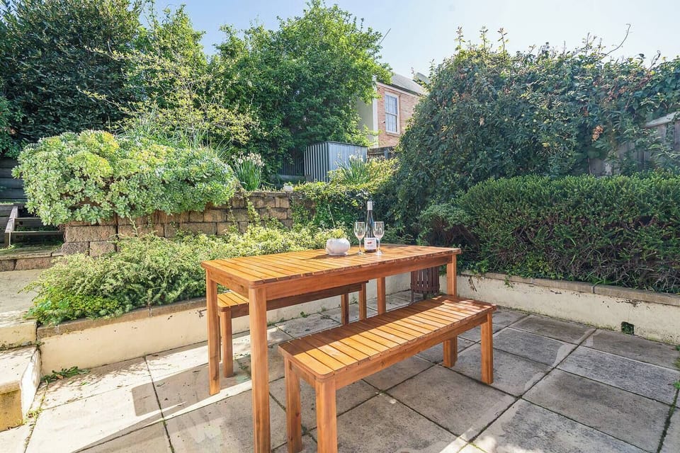 This sunlit corner of the patio invites lazy lounging with a book or wine in hand, surrounded by natural beauty and fresh air.