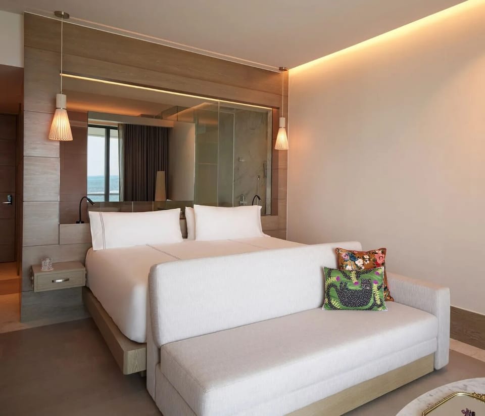 Sink into crisp linens in a warm, modern king room.