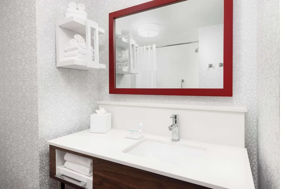 Refresh in a bright, spotless bath with fluffy towels ready.