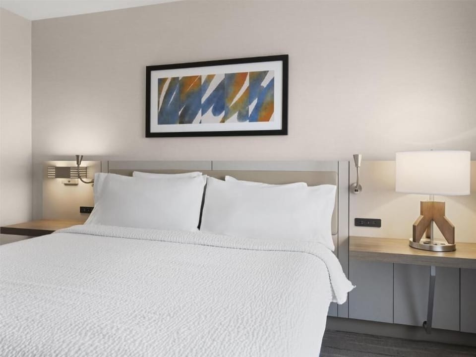 Enjoy crisp linens and soft bedside lighting for restful nights.