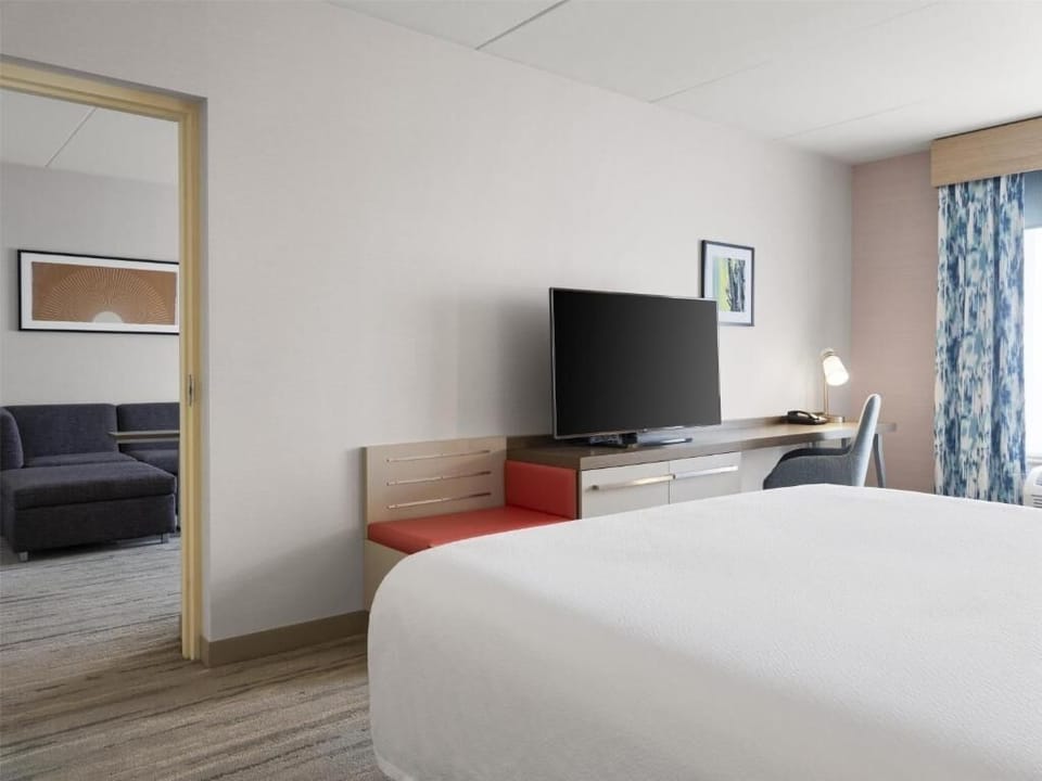 Unwind in a bright bedroom with big TV comforts.