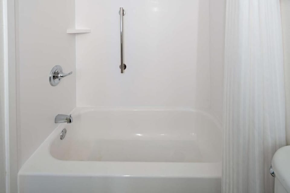 Unwind with a warm soak in the bright, clean tub.