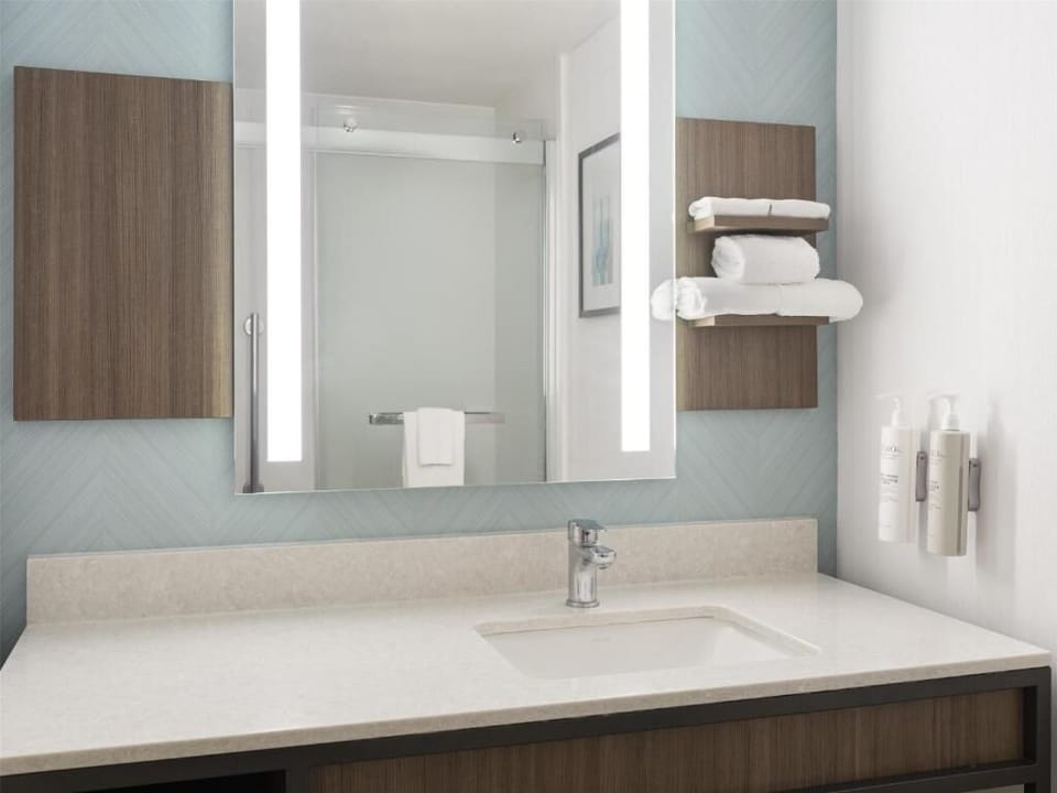 Refresh at the sleek vanity with bright, spa-like mirror.