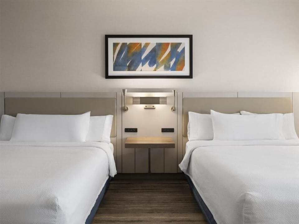 Drift off between crisp linens and soothing bedside lighting.