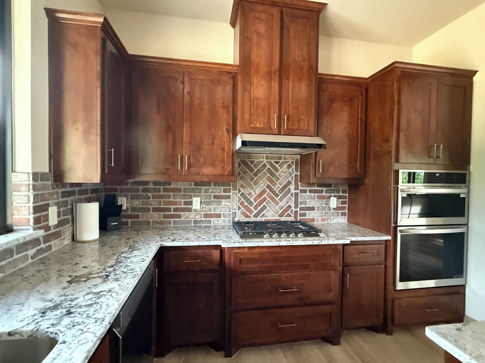 Kitchen with gas stovetop.  Microwave and oven nearby.