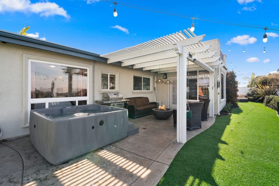 And here’s your backyard getaway with a hot tub and space to unwind.