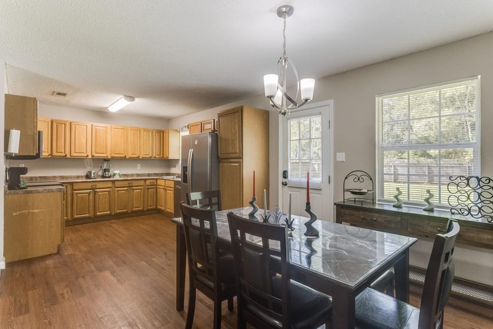 Share meals at the dining table with seating for six, steps from the kitchen.