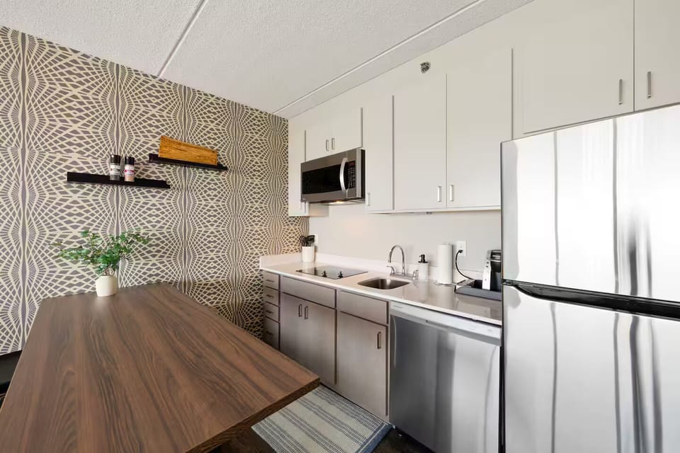 Modern kitchen with stainless appliances & chic dining bar for meals or coffee