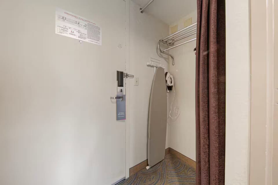 Entryway with open closet, luggage rack & ironing station for travel ease