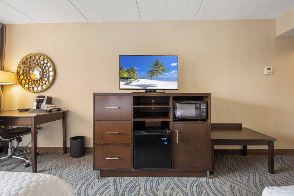 Modern entertainment area with TV, mini fridge & microwave for relaxing stays