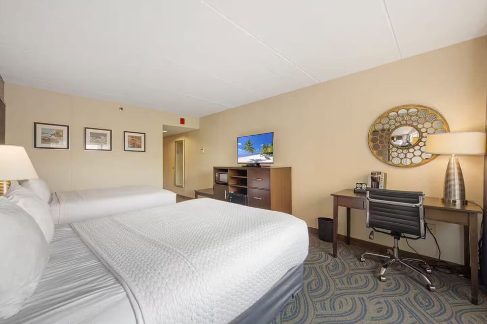Bright double queen room with TV, desk, in-room microwave, fridge & coffee maker